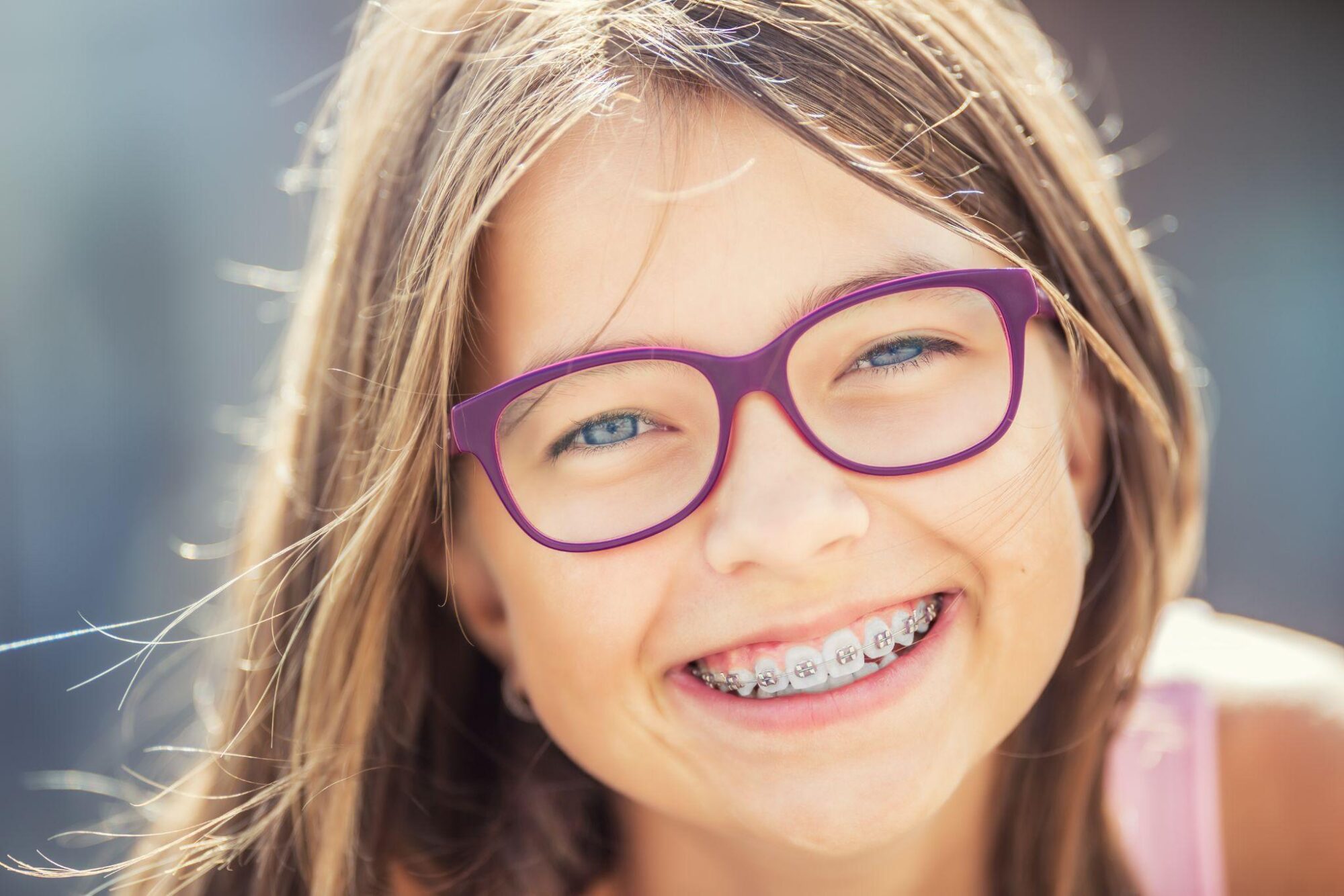 Young girl with braces smiling - orthodontist for kids in Irvine CA Shining Smiles
